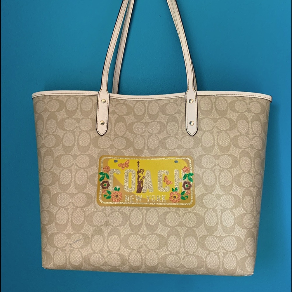 Coach logo print tote with New York license plate.